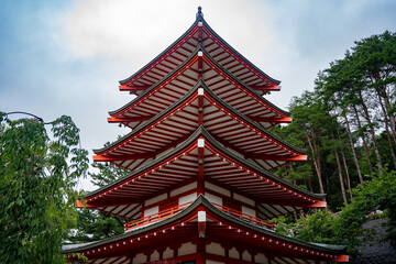 Obraz premium Big red shrine perched on a peaceful hillside, surrounded by lush greenery.
