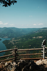 Wooden fence and observation binoculars overlooking the Drina River canyon and Perucac lake...