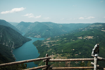 Wooden fence and observation binoculars overlooking the Drina River canyon and Perucac lake...