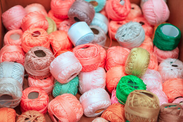 Vibrant collection of embroidery floss spools, showcasing a spectrum of colors. Threads in a multitude of hues, waiting to be used in needlework