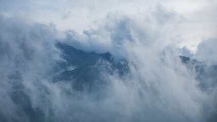 Fog flowing on hills and sky