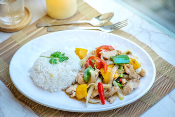 A plate of delicious Pad Thai with chicken, vegetables, and rice.