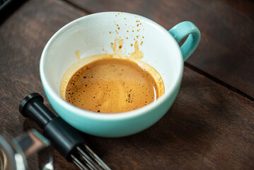 Espresso Tools: Professional Portafilter and Glass Cup with Rich Crema on Rustic Wooden Table Espresso Perfection: Dark Roast Coffee with Crema, Portafilter, and Chrome Machine Parts on Wood