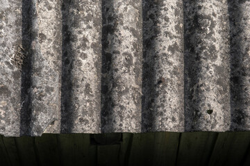 Old and very dangerous asbestos roof. Asbestos dust in the environment. Asbestos removal