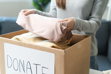 Organize closet and storage concept, people prepare unwanted old fashion clothes for share donation.