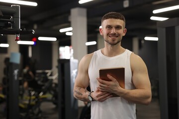 Personal trainer with tablet in sport center