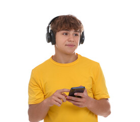 Teenage boy in headphones with smartphone on white background
