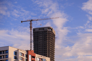 Fototapeta premium Construction of buildings and high-rise cranes against the sky