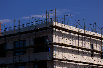 Construction of buildings, a multi-story building against the sky