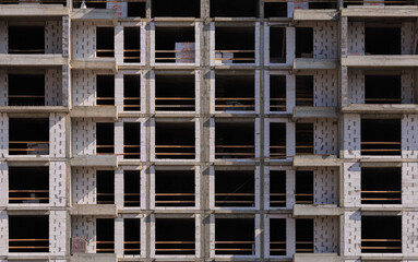 Construction of buildings, a multi-story building against the sky