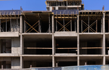Construction of buildings, a multi-story building against the sky