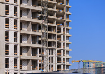 Construction of buildings, a multi-story building against the sky