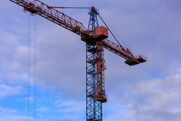 Construction of buildings and high-rise cranes against the sky