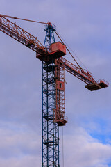 Construction of buildings and high-rise cranes against the sky