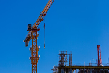 Naklejka premium Construction of buildings and high-rise cranes against the sky