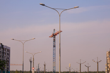 Construction of buildings and high-rise cranes against the sky