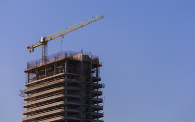 Naklejka premium Construction of buildings and high-rise cranes against the sky