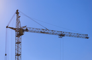 Construction of buildings and high-rise cranes against the sky