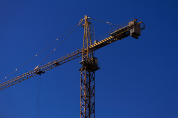 Construction of buildings and high-rise cranes against the sky