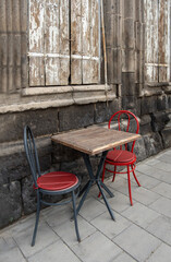 table and chairs at a street cafe in the old town
