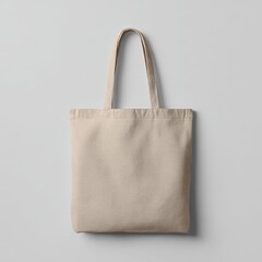 Beige canvas tote bag, simple and minimalist design, hangs against a neutral backdrop