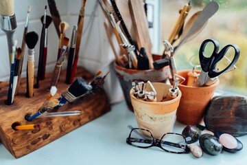 Art tools creatively arranged on a studio desk.