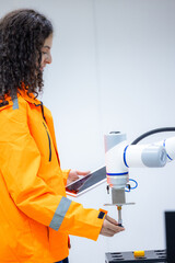 Female industrial engineer study inspection control robot arm machine in robotics engineering,...