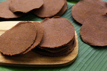 Fermented soybean discs, known as “Thua Nao,” a traditional Thai seasoning used to enhance flavor in Northern cuisine.