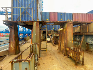 Cargo area of containers ship with loaded containers on hatch covers in. very poor and rust...