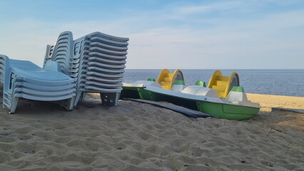 Stack of sun loungers on the beach.  Start or end of the summer season at the resort city. Heap of...