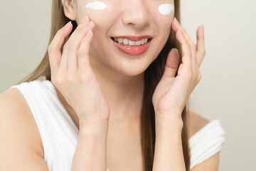 Routine skin care concept, Close-up woman applying cream on her face