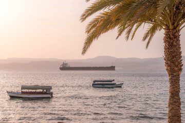 View of cruising boats and touristic vessels on the tranquil waters of the Red Sea near Aqaba beach...