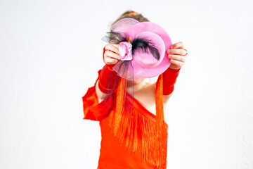5-year-old blonde girl, little aspiring dancer in vibrant red dress with hat performs Latin dance...