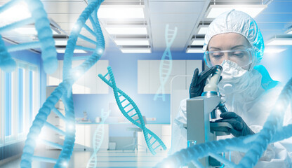Scientist in protective suit examines DNA through microscope in high-tech laboratory. Concept:...