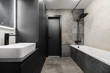 Modern minimalist bathroom design featuring sleek fixtures and stylish decor elements in a...