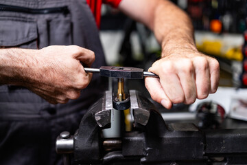 Close up view of mechanic hands working with metal.