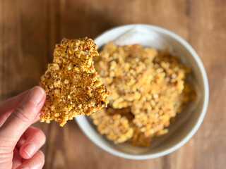 Person Holding a Crunchy Homemade Granola Cracker