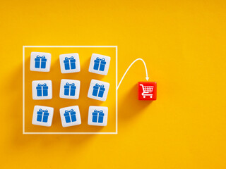 Shopping cart receiving many gifts on yellow background