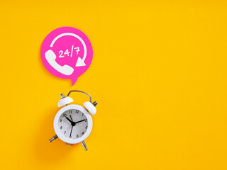 24/7 open call center service, hotline support available anytime with alarm clock on yellow background