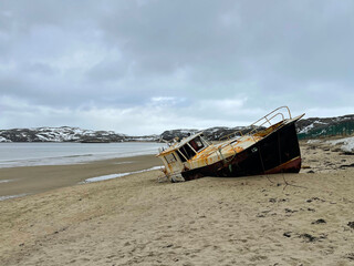 Old fishing schooner in the bay of the Barents Sea, Teriberka, Russia