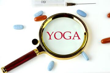 The word YOGA written through a magnifying glass on a white background