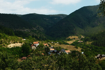 Fototapeta premium Sunny panorama of Mokra Gora village and surrounding green mountains, Western Serbia.