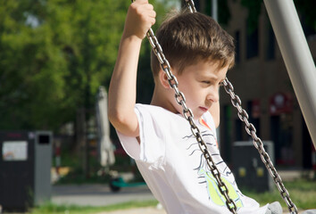 Cute boy playing on playground, enjoying outdoor activity