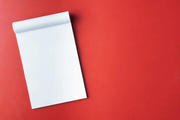 White Notepad on a Bright Red Background for Creative Ideas