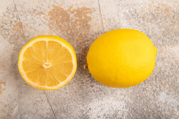 Yellow Lemon Cut in half on brown concrete, Top view, close up