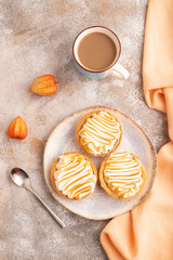 French lemon tart with meringue on brown concrete, orange linen textile, top view, flat lay, close up