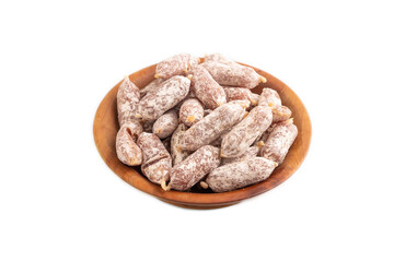 Small smoked Chicken sausages in wooden bowl isolated on white. side view, close up