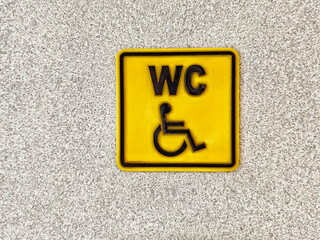 Sign indicating accessible restroom facilities for individuals with disabilities located in a...