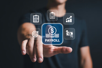 Businessman touching digital payroll icon with related business and finance symbols on a virtual interface