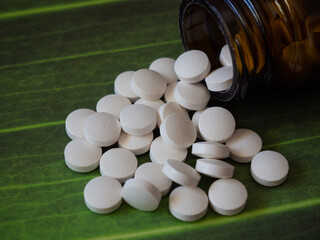 White pills on a green background